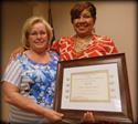 Judy Hall of Carpenters Southwest Apprenticeship Trust receives her certificate of retirement from Business Manager Jacqueline K. White-Brown, after over 36 years of service.