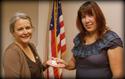 Olivia Holton of ILWU Local 13 receives her 5-year pin from President Laura Villegas.